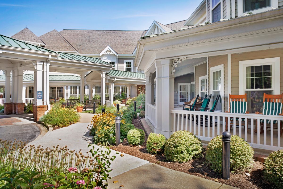 A charming building with a beautifully landscaped garden and inviting porch.