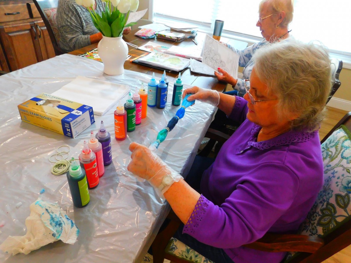 Seniors enjoying a painting and crafting session.