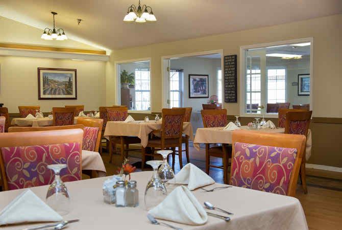 A cozy and well-decorated dining room with neatly arranged tables and chairs.