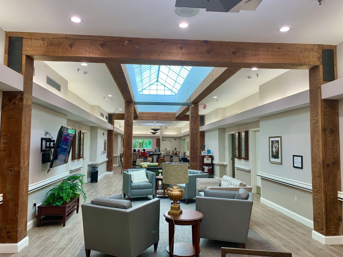 A modern lobby with comfortable seating and a skylight.