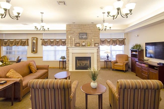 A cozy living room with a fireplace, comfortable seating, and elegant lighting.