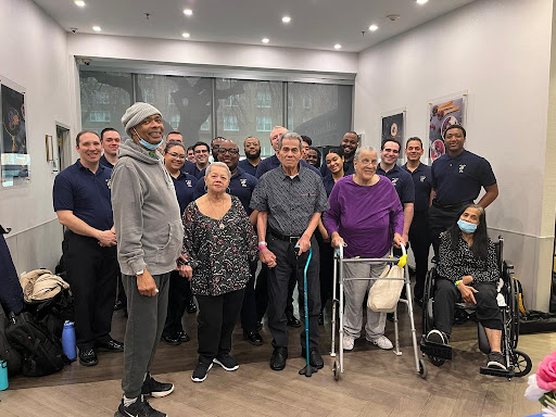 A warm gathering of community members, showcasing intergenerational support and camaraderie.