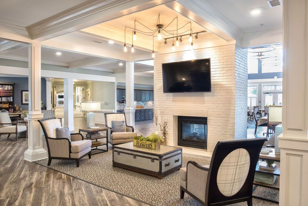A modern living room with elegant furniture, a fireplace, and contemporary lighting.