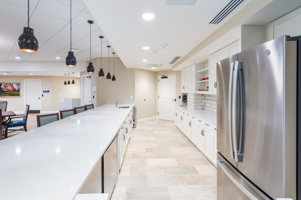 A sleek, modern kitchen with stainless steel appliances and ample lighting.