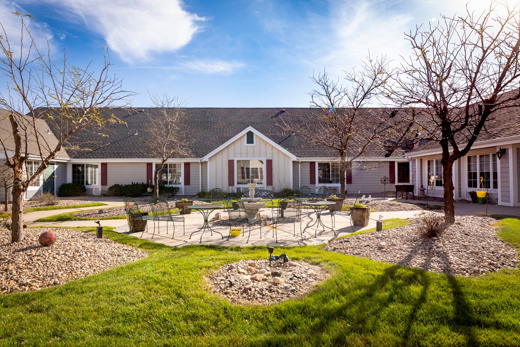 A charming residential house with a well-maintained yard and clear blue sky.