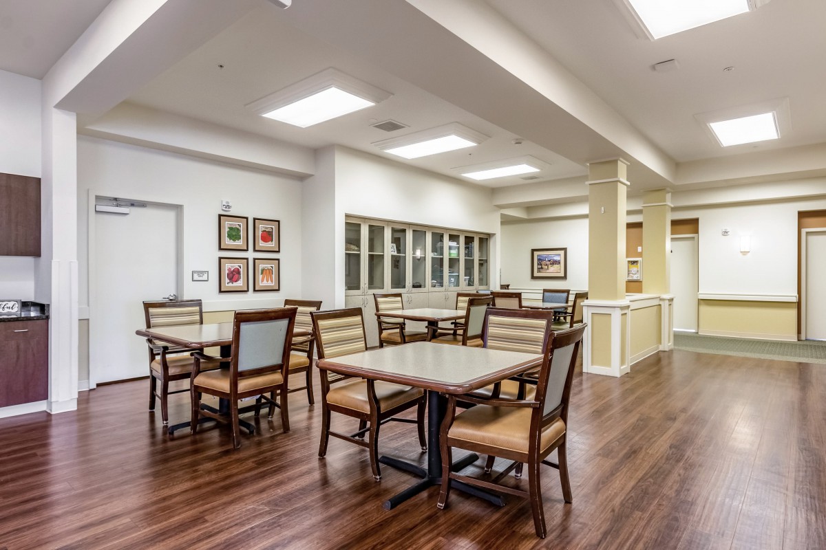 Modern dining area with wood flooring and simple decor.
