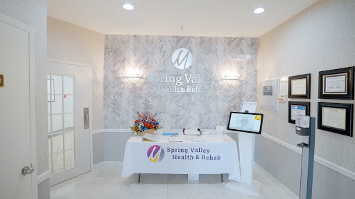 A modern and welcoming reception area of a wellness spa, featuring floral arrangements and informative displays.