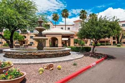 A scenic hotel entrance with a fountain and desert landscaping.