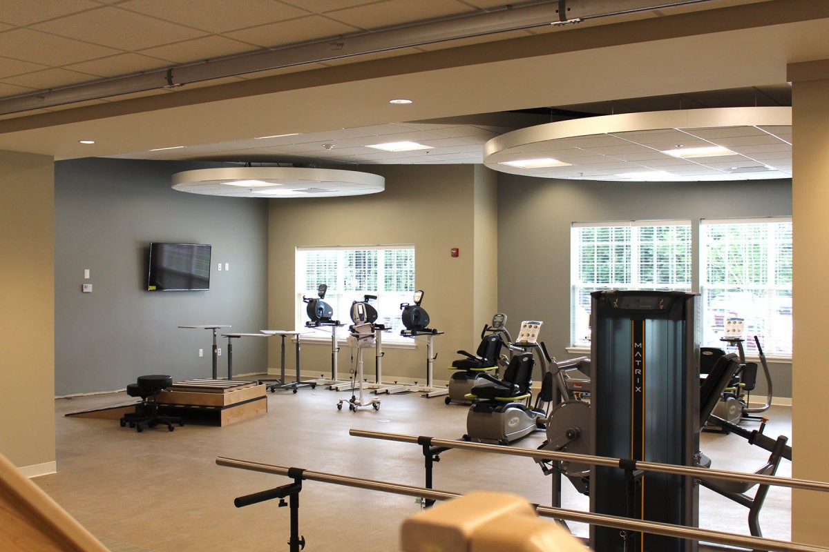 A modern fitness center with various exercise equipment, including treadmills and exercise bikes.