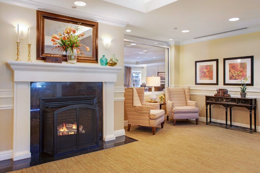 A cozy living room with a warm fireplace, comfortable seating, and tasteful decor.