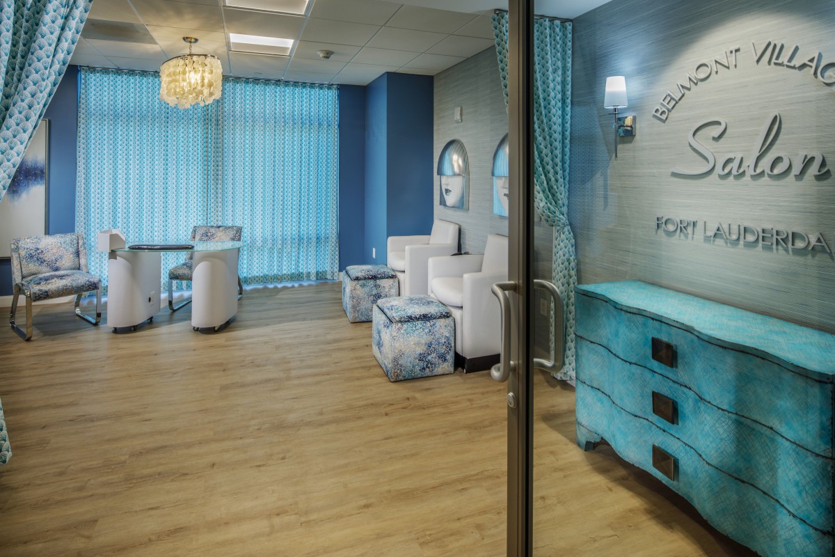 A modern salon waiting area with blue-themed decor and comfortable seating.
