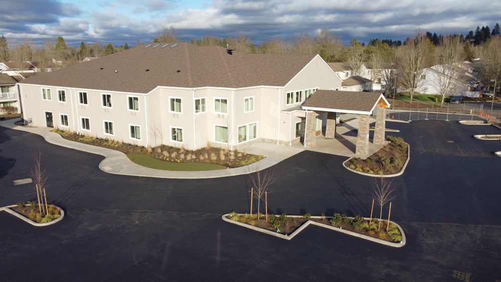 Aerial view of a modern residential building with landscaped surroundings.