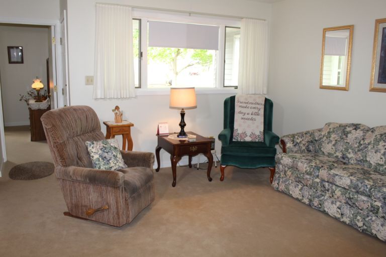 A cozy living room with comfortable seating and a warm lamp.