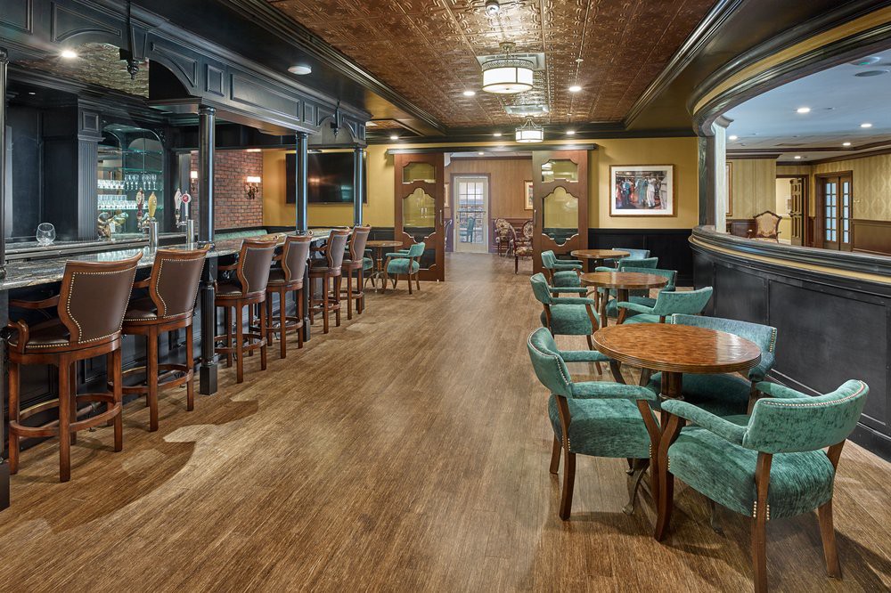 Cozy bar and restaurant interior with wooden flooring and comfortable seating.