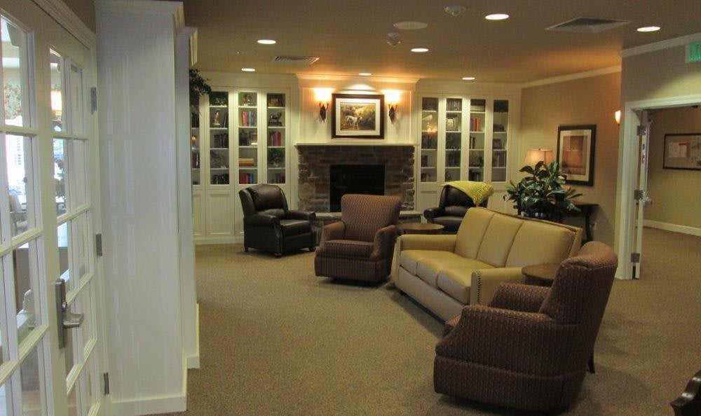A cozy living room with comfortable seating and a warm fireplace.