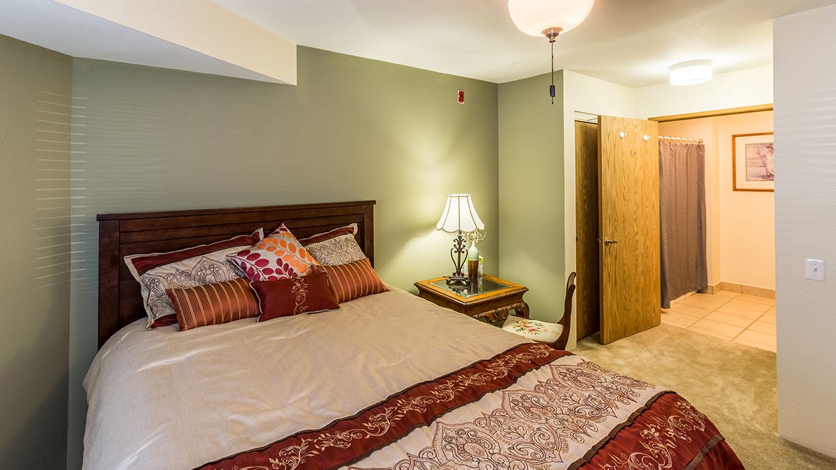 A cozy bedroom with warm decor and inviting lighting.