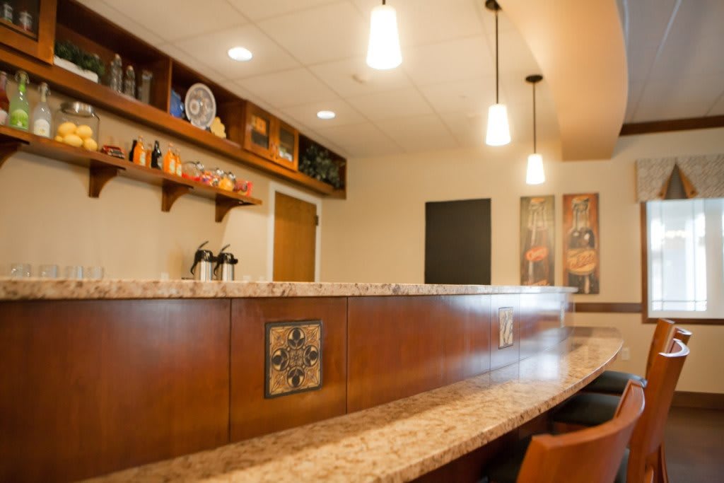 A stylish bar area with pendant lighting and modern design elements.