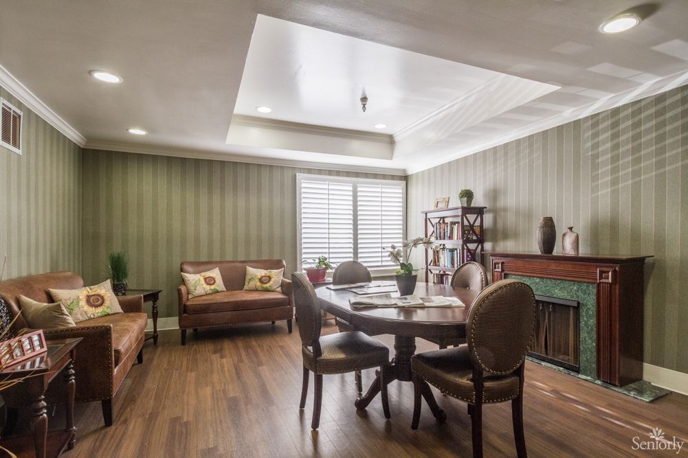 A cozy living and dining area with elegant furniture and warm lighting.