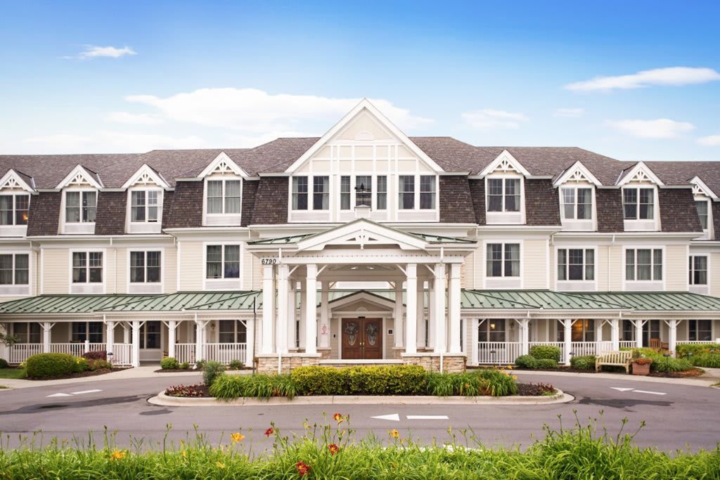 A front view of a large colonial-style building with symmetrical design.