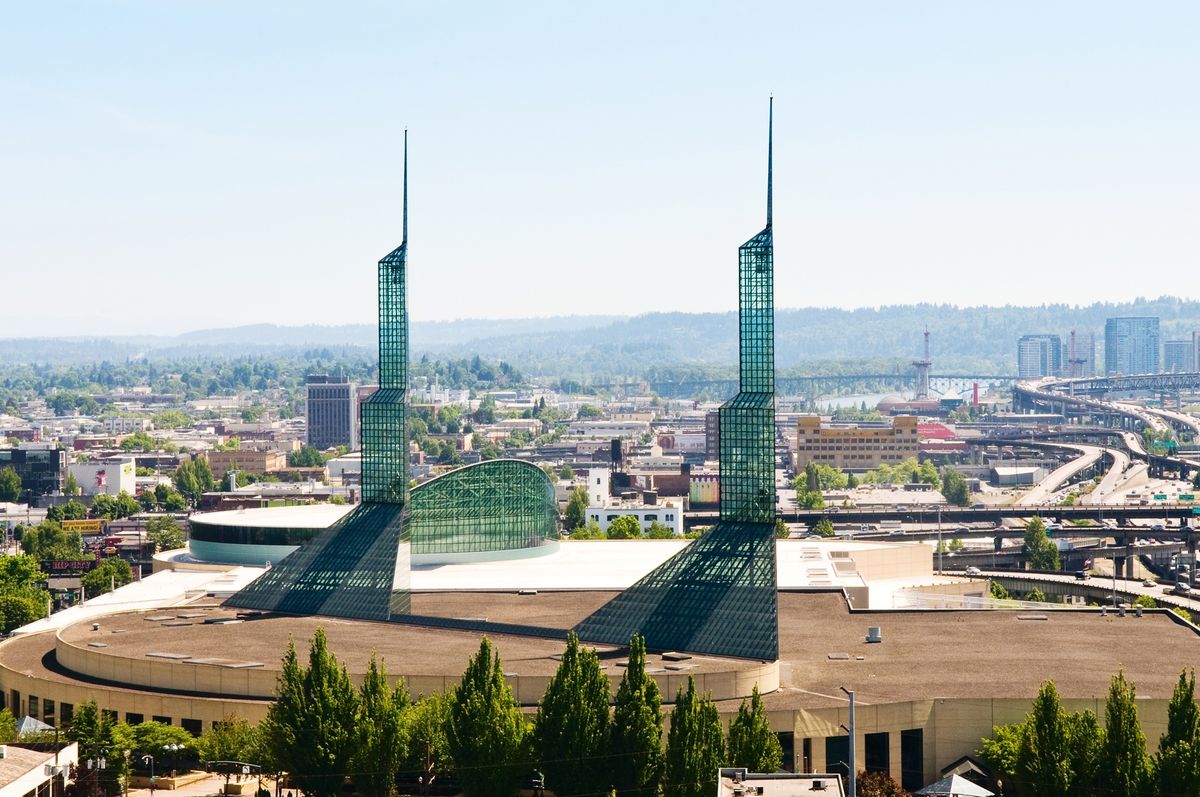 A city view featuring a prominent modern architectural landmark with two tall spires.