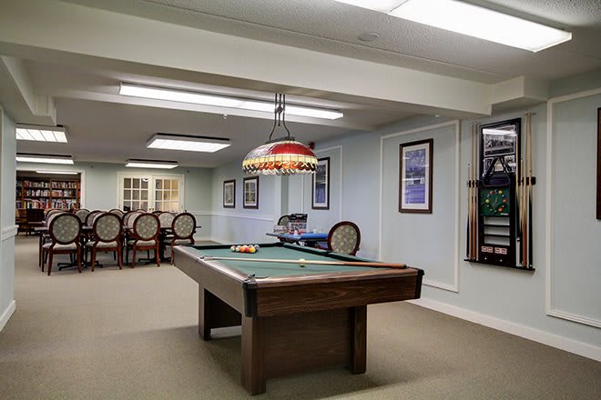 A cozy game room featuring a classic billiards table and stylish decor.