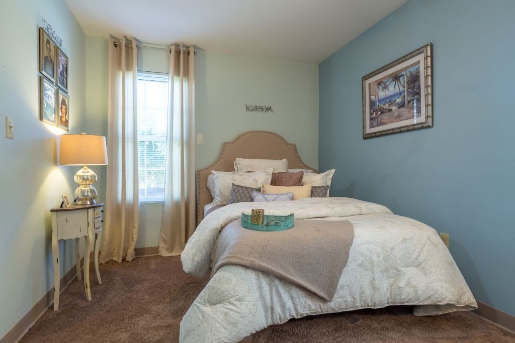 A cozy and well-decorated bedroom with soft colors, an inviting bed, and elegant decor.