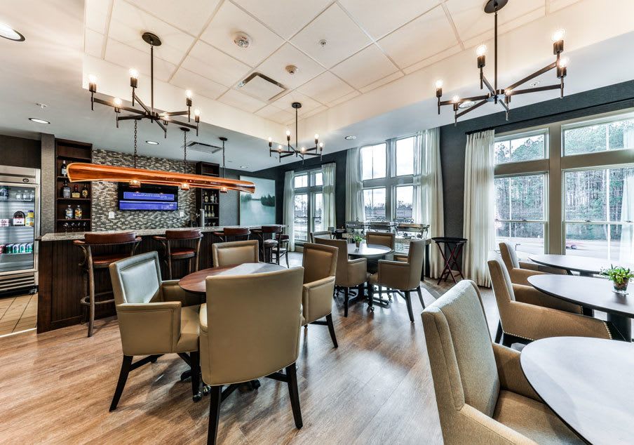 A modern restaurant interior featuring comfortable seating and elegant lighting.