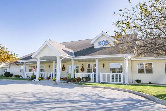 A suburban residential house with a front porch and well-maintained exterior.