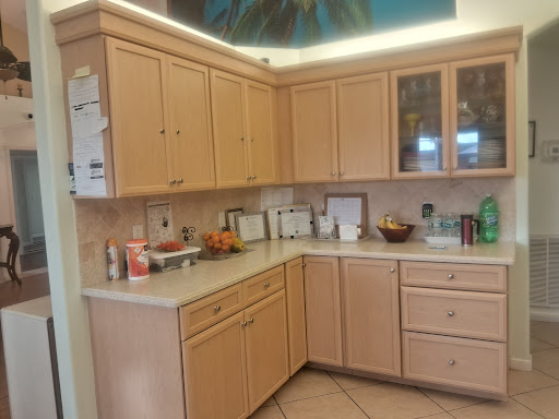 A cozy kitchen featuring wooden cabinets and a well-organized countertop.