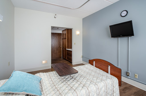 A cozy and modern bedroom featuring a wooden bed and a wall-mounted television.
