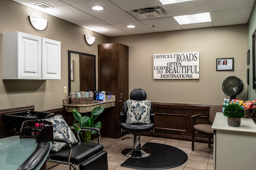 A cozy and inviting hair salon setup with comfortable seating and a stylish barber chair.