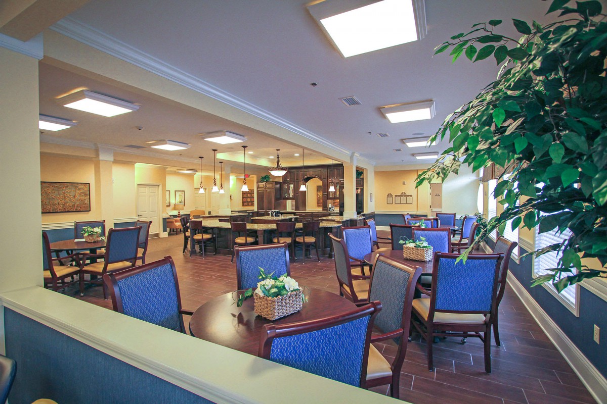 A spacious and well-lit dining area with modern decor and comfortable seating.