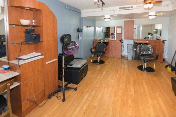 A well-organized hair salon interior with chairs and equipment.