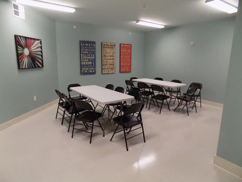 A conference room with tables and chairs arranged for a meeting.