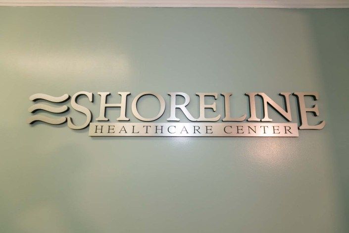 Sign for Shoreline Healthcare Center on a wall.