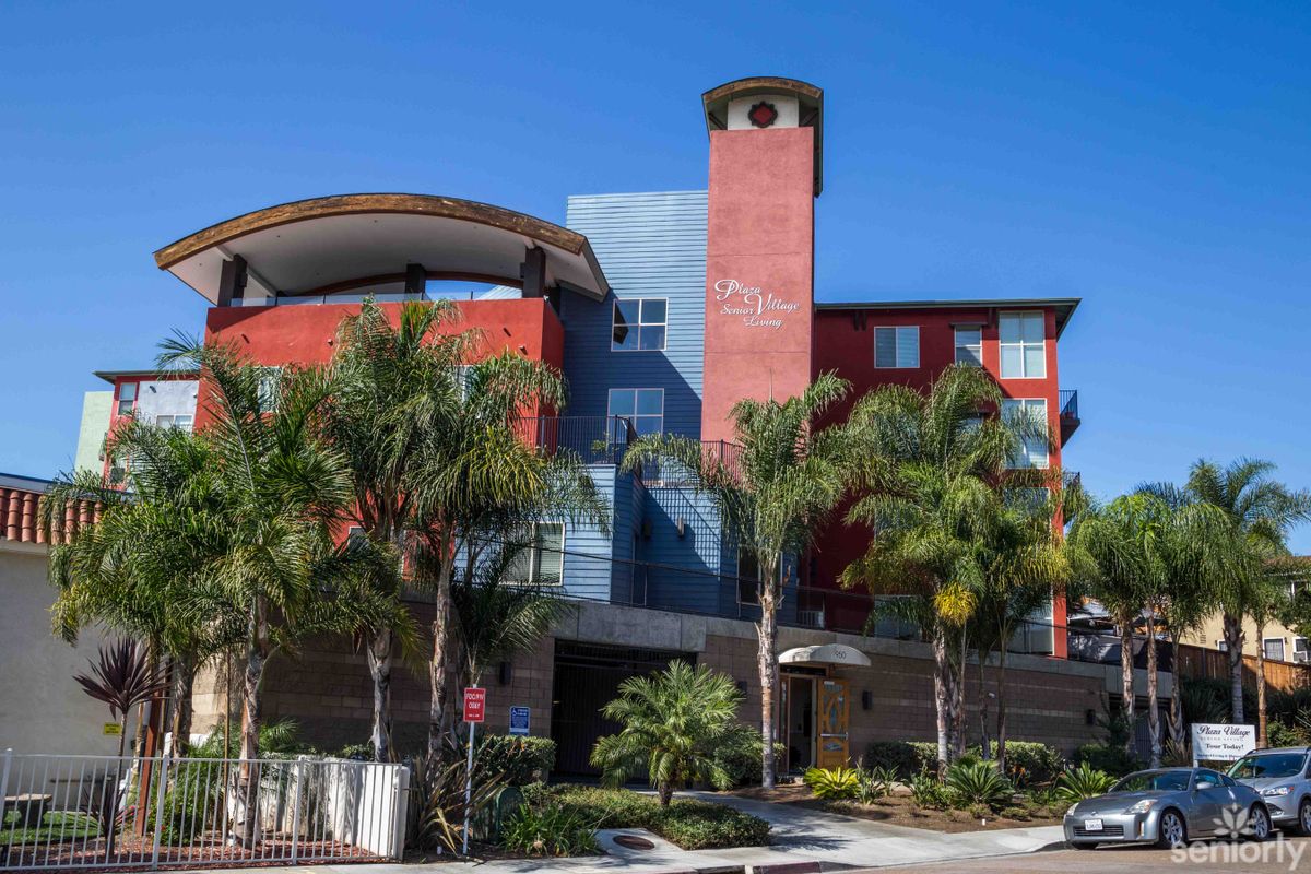 Modern apartment building with palm trees in an urban setting.
