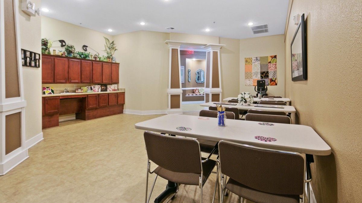 A well-lit conference room with tables and chairs arranged for a meeting.