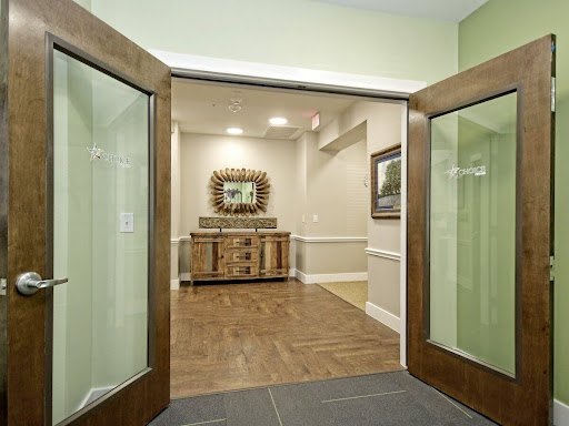 A welcoming entrance featuring elegant wooden doors leading into a tastefully decorated reception area.