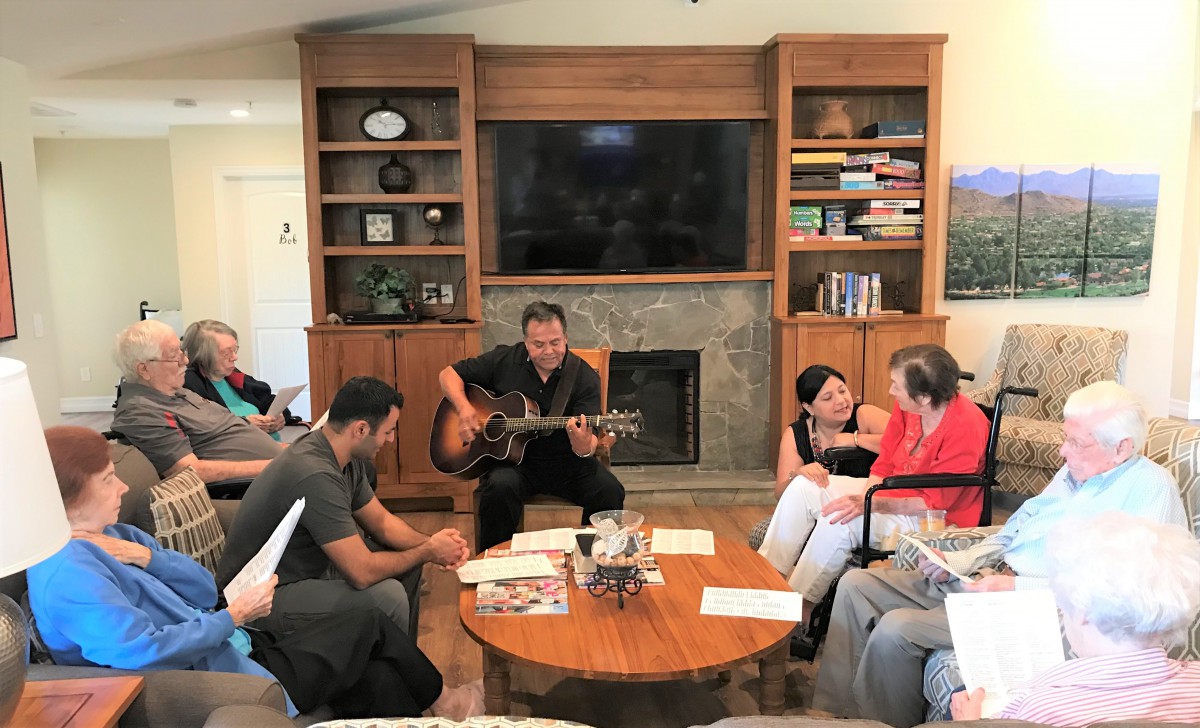 A group of people enjoying music together in a cozy living room setting.