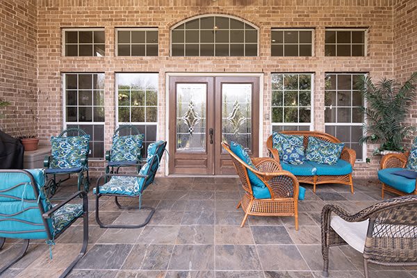 A cozy outdoor patio featuring comfortable seating and decorative cushions.