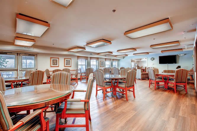 A bright dining area with neatly arranged tables and chairs.