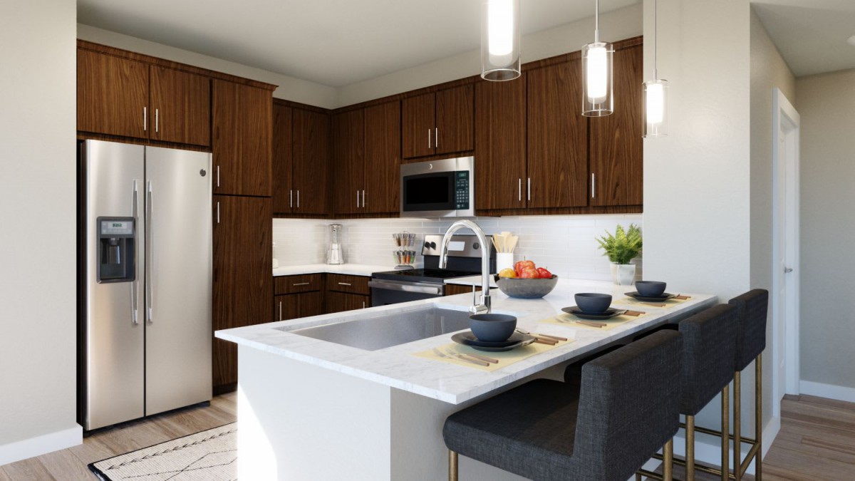 A modern kitchen with wooden cabinets, an island, and contemporary lighting.