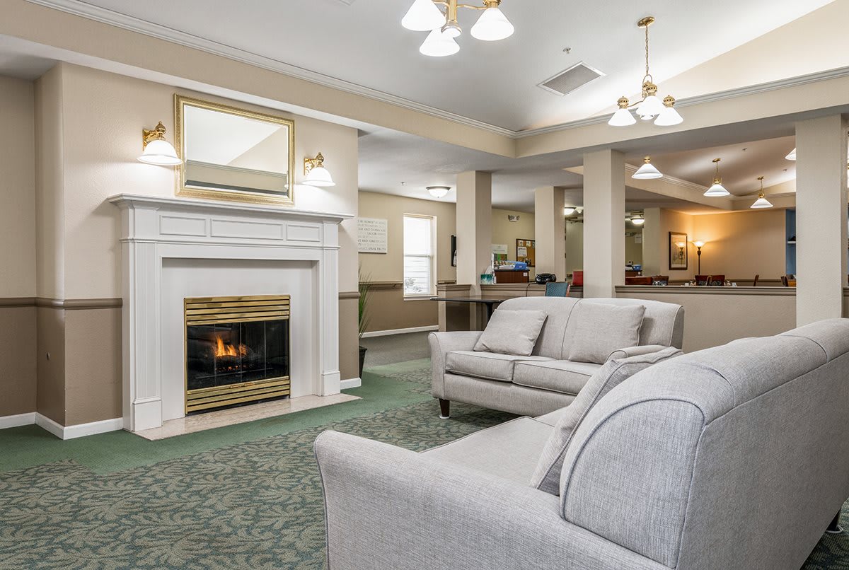 A cozy living room with a fireplace and comfortable seating.