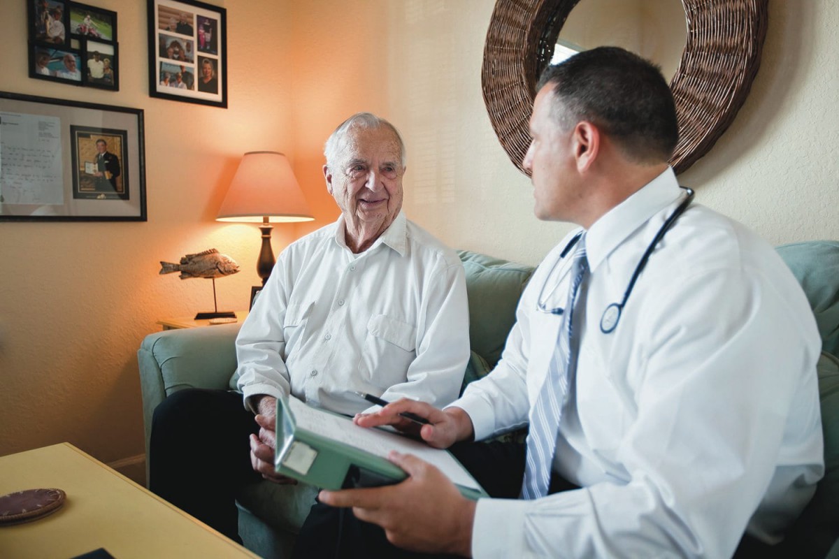 A doctor and patient engaged in a medical consultation in an office setting.