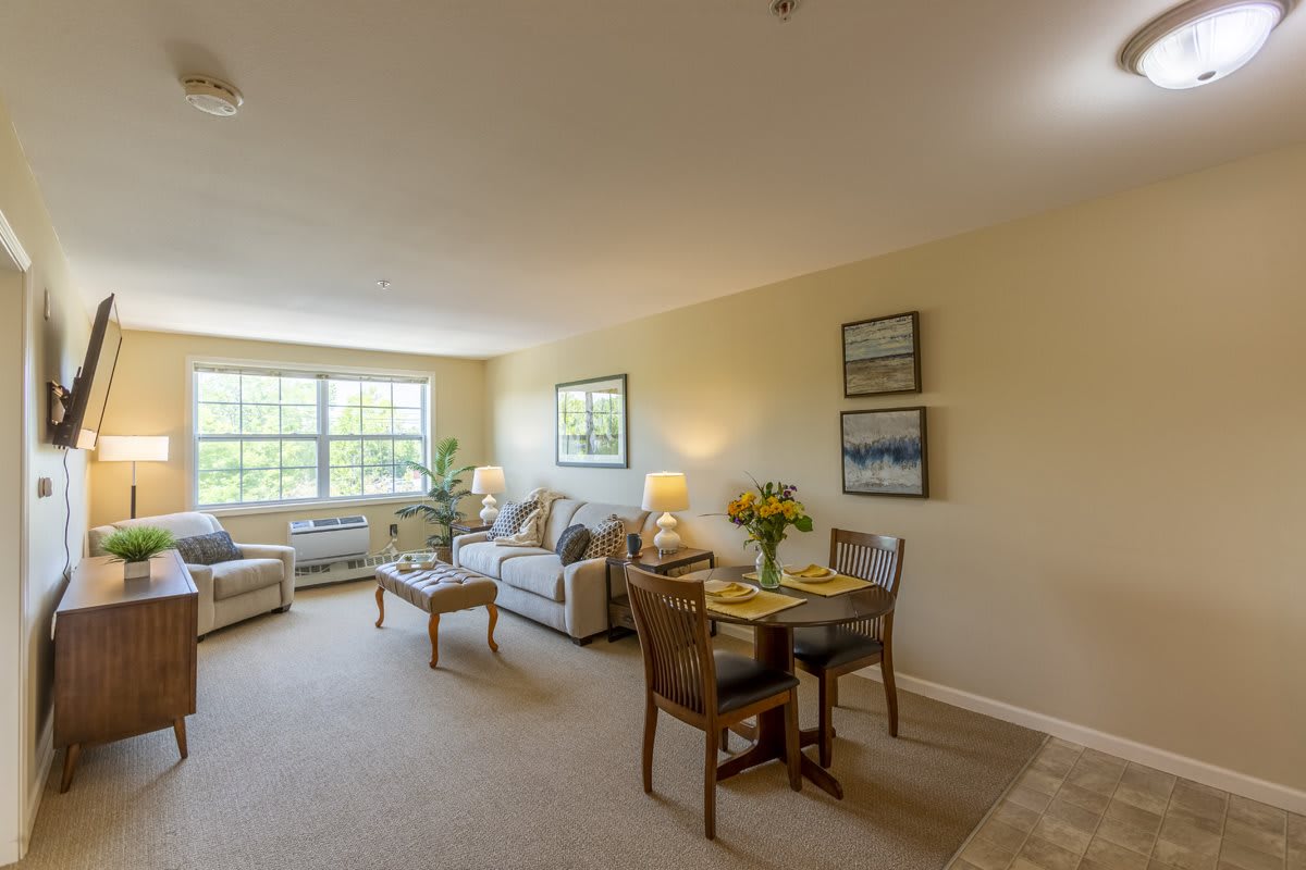 A cozy living and dining area with elegant furniture and natural light.