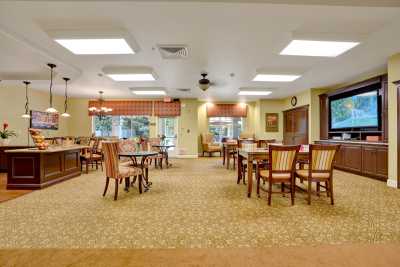 A well-lit dining area with multiple tables and chairs arranged neatly.