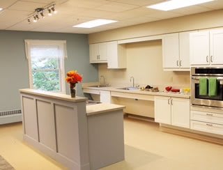 A modern kitchen with white cabinetry and sleek appliances.