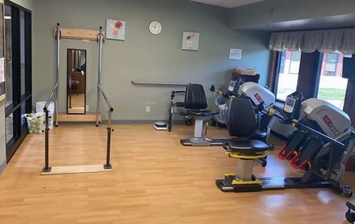 A therapy room with exercise equipment for rehabilitation and fitness activities.
