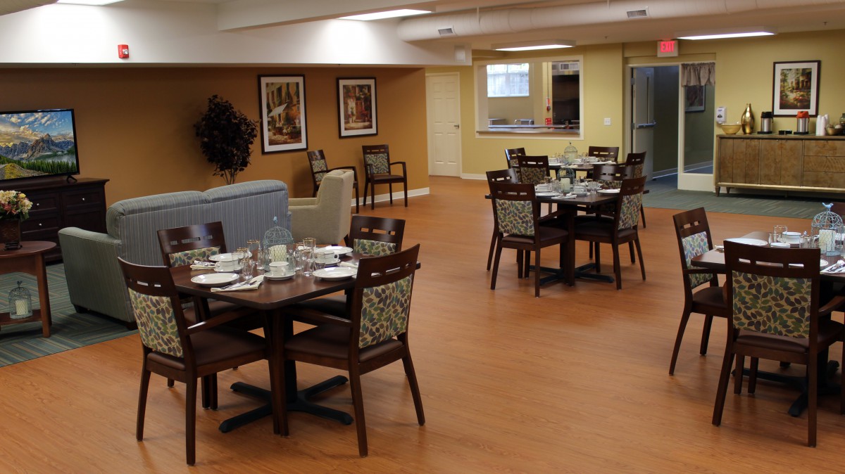 A cozy dining area with neatly set tables and comfortable seating.