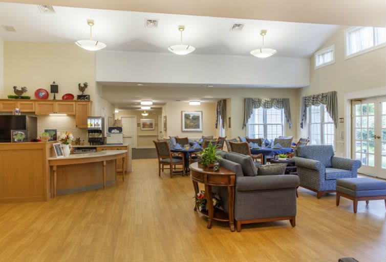 A cozy community living room with comfortable seating and warm lighting.